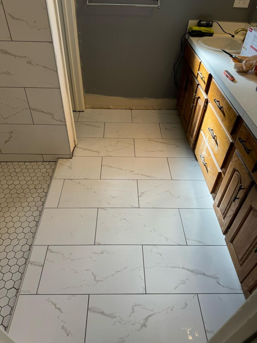 New white marble-look floor tile laid in a staggered pattern